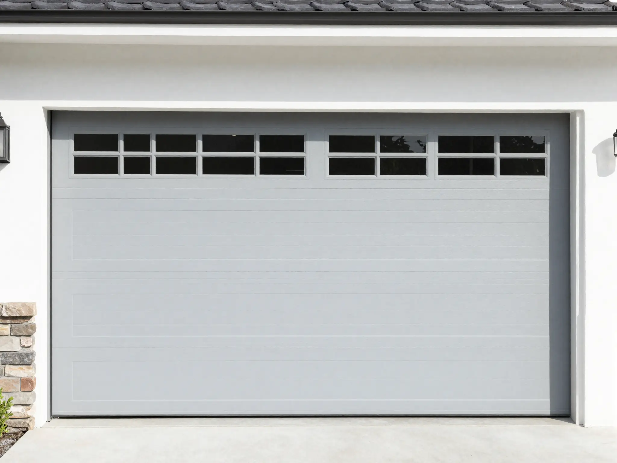 Light gray steel sectional garage door